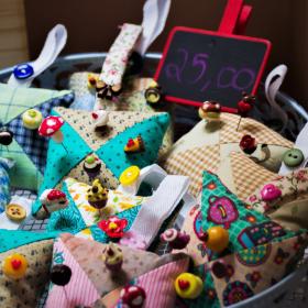 A bin full of pin cushions for sale