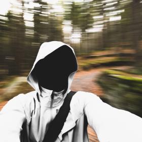 Photo of a empty white hoodie in front of a moving background.