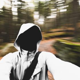 Photo of a empty white hoodie in front of a moving background.